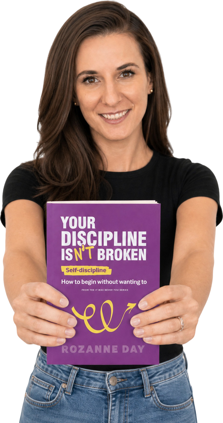 Rozanne Day holding the paperback of Your Discipline Isn't Broken out toward the camera with both hands, smiling.
